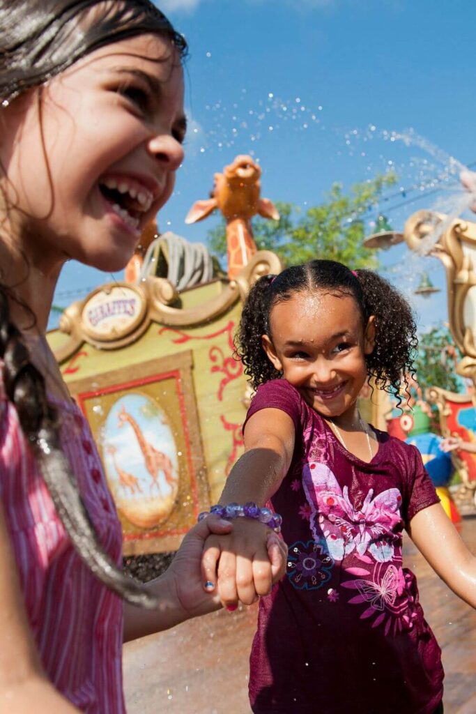 Photo of two kids playing in the water at the Casey Jr. Splash n Soak Station at Magic Kingdom.