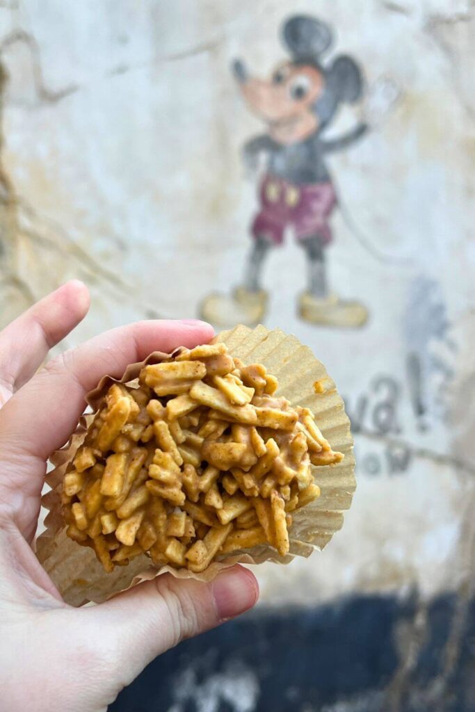 Photo of a peanut butter haystack in front of a wall with Mickey Mouse painted on it.