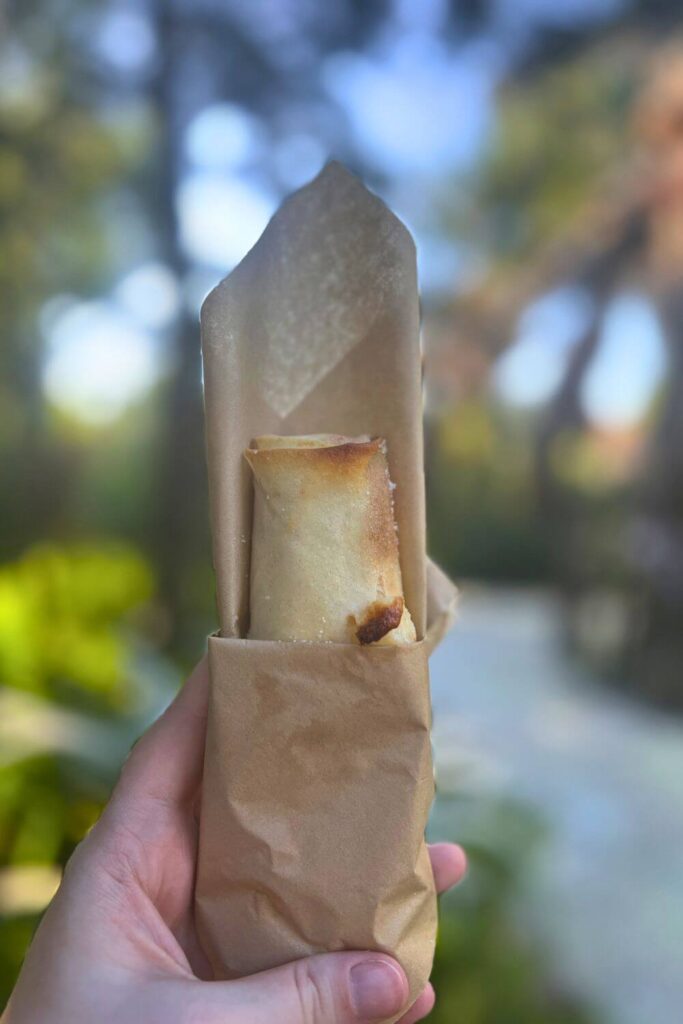 Photo of a pineapple pongu lumpia in a folded napkin.