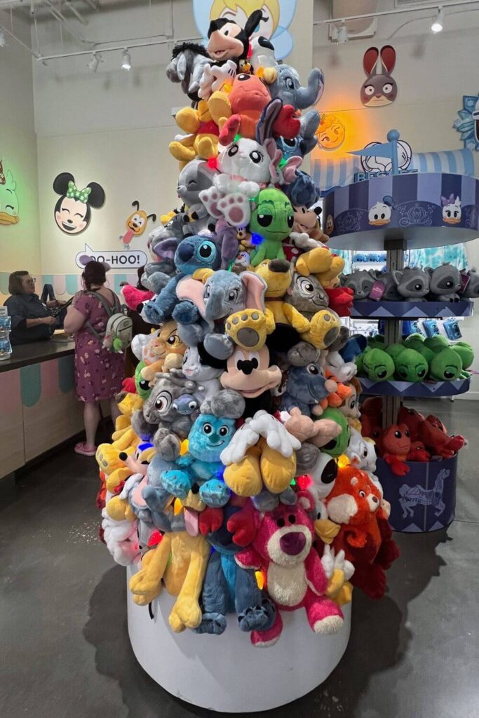 Photo of the stuffed animal tower shaped like a Christmas tree inside Disney Ever After store at Disney Springs.