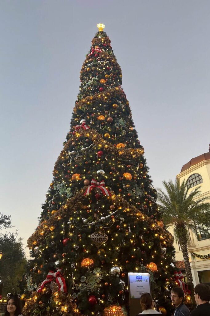 Photo of the main Christmas tree at Disney Springs during dusk.