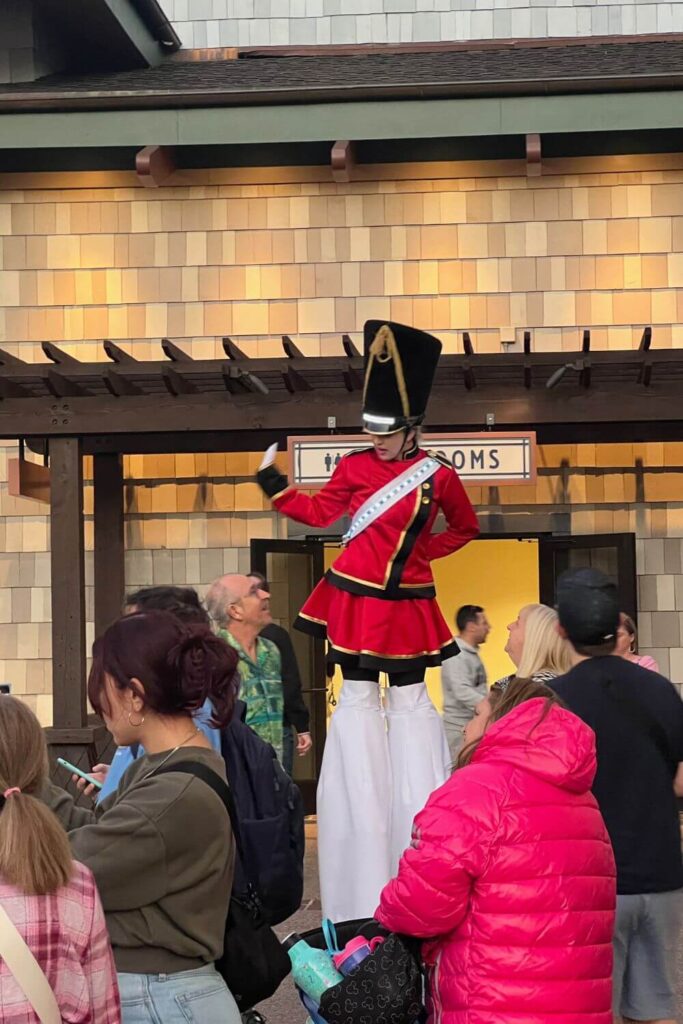 Photo of a stilt walking performer dressed as a toy soldier while entertaining guests at Disney Springs.