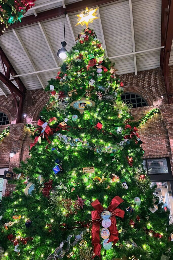 Photo of the 2024 Disney World Annual Passholder tree at Disney Springs at night with the lights on.